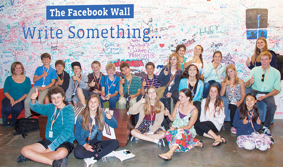 Image of FastForward reporters posed before the Facebook 'wall'
