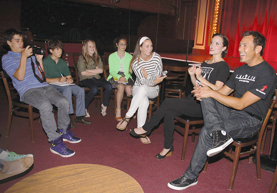 A group of FastForward Adventure Reporters interviewing members of the Beach Blanket Babylon cast