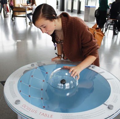 Image: A curious reporter checks out the Exploratorium's Oculus Table exhibit