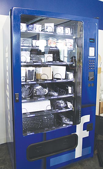 Image of a vending machine at Facebook headquarters that dispenses worker needs such as computer keyboards, etc.