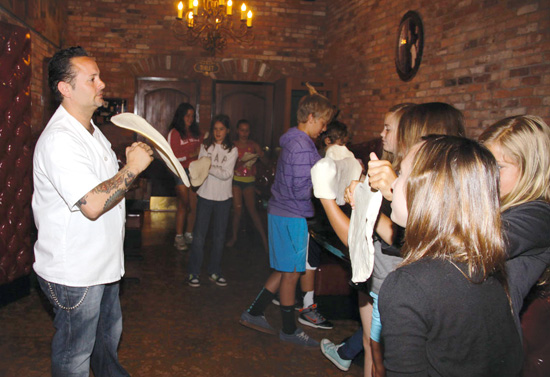 Image of Tony Gemignani showing the FastForward reporters how to toss and make pizza